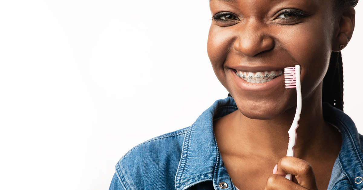 Young girl brushing her braces