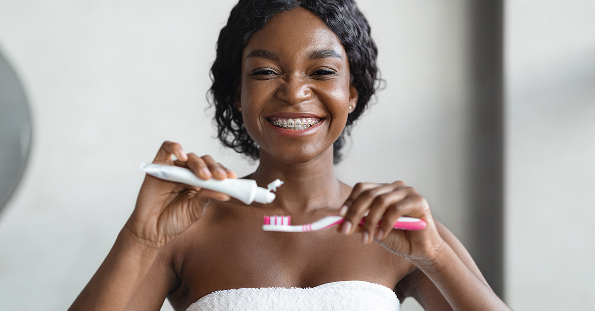 woman brushing her braces